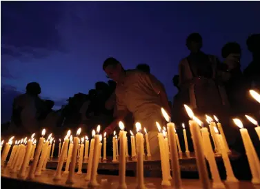  ?? A candle-light vigil for the soldiers who were killed in the attack on the Indian army base in Uri, Kashmir, in Ahmedabad on Thursday. REUTERS ??