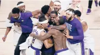  ?? JOHN RAOUX/AP ?? The Los Angeles Lakers celebrate after defeating the Miami Heat in Game 6 to clinch the franchise’s 17 NBA title.