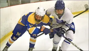  ?? CHRIS CHRISTO — BOSTON HERALD ?? Walpole, MA - February 4, 2024: Norwood’s Anthony Ricciardi goes after the puck in a corner with Braintree’s Andrew Gaffney.