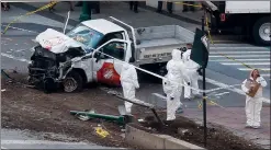  ?? AP PHOTO BEBETO MATTHEWS ?? Authoritie­s stand near a damaged Home Depot truck after a motorist drove onto a bike path near the World Trade Center memorial, striking and killing several people Tuesday in New York.
