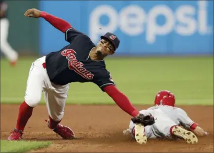  ?? TONY DEJAK — THE ASSOCIATED PRESS ?? Francisco Lindor reaches but can’t get to a ball thrown by catcher Yan Gomes as the Reds’ Billy Hamilton slides safely to second base on a steal in the seventh inning on July 9.