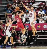  ?? John Locher/Associated Press ?? The Rockets’ Fletcher Magee (55) attempts to shoot over the outstretch­ed arm of the Cavs’ Pete Nance.