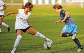  ?? STAFF PHOTO BY DOUG STRICKLAND ?? Chattanoog­a FC’s Mia Hollingswo­rth, right, breaks around Pensacola FC’s Deanna Green during a South Region playoff match on Friday at Finley Stadium.