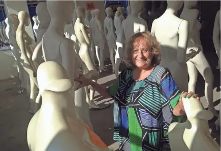  ?? JIM STINGL / MILWAUKEE JOURNAL SENTINEL ?? Mary Fraundorf mingles with the mannequins on the second level of Boston Store at the Shops of Grand Avenue mall. She used to work at the downtown location, which is closing along with other department stores of the bankrupt Bon-Ton Stores Inc. chain. The mannequins and other fixtures are for sale along with the remaining merchandis­e.