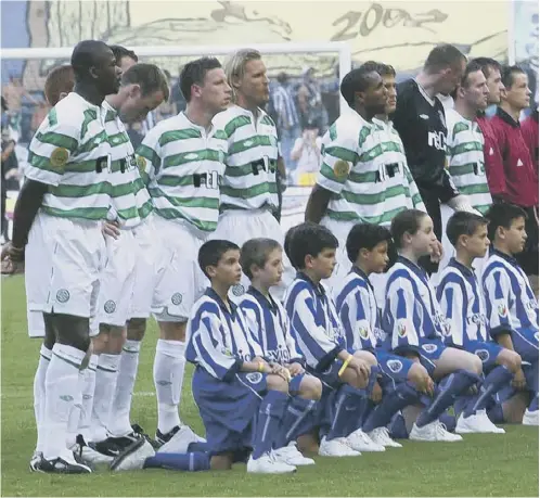  ?? ?? 0 The Celtic team lines up with the Porto mascots before taking on the Portuguese side in the 2003 Uefa Cup final in Seville