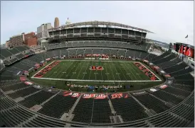  ?? AARON DOSTER — THE ASSOCIATED PRESS ?? Players walk out to the field before at Paul Brown stadium that is devoid of fans in Cincinnati Sept. 13. About one in six Ohio school districts asked the state for permission to add additional spectators for fall sporting events, exceeding the limits set by Gov. Mike DeWine in last month’s sports order, records show.