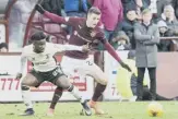  ??  ?? 2 Larnell Cole, left, takes on Hearts’ Andraz Struna during a game which the Inverness midfielder says was ‘something to build on’.