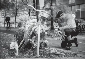  ?? SAM HODGSON / THE NEW YORK TIMES ?? Eric Fleming pays his respects Thursday at a makeshift memorial set up for the victims of Tuesday’s terror attack in New York. A man driving a truck plowed through a bicycle path for multiple blocks, killing eight people and injuring at least 11.