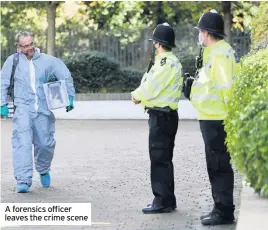  ??  ?? A forensics officer leaves the crime scene