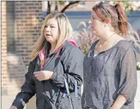  ?? CP PHOTO ?? Amanda Blanchette, right, sister of victim Terry Blanchette, arrives at the courthouse in Lethbridge, Alta., on Wednesday. Derek Saretzky, 24, was sentenced to 75 years in prison for three counts of first degree murder in September 2015, of Terry...