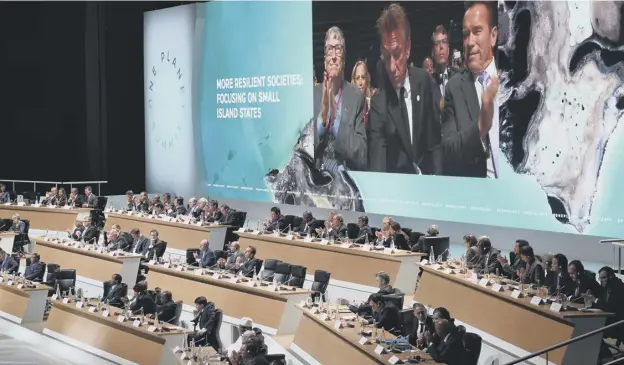  ?? PICTURE: AFP/GETTY IMAGES ?? 0 Bill Gates, Sean Penn and Arnold Schwarzene­gger are pictured on a big screen above delegates as they attend the One Planet Summit yesterday