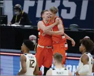  ?? DARRON CUMMINGS - THE ASSOCIATED PRESS ?? Syracuse’s Buddy Boeheim (35) ad Marek Dolezaj (21) celebrate following a second-round game against West Virginia in the NCAA men’s college basketball tournament at Bankers Life Fieldhouse, Sunday, March 21, 2021, in Indianapol­is. Syracuse defeated Syracuse 75-72.