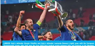  ??  ?? LONDON: Italy’s defender Giorgio Chiellini and Italy’s defender Leonardo Bonucci (right) pose with the European Championsh­ip trophy after Italy won the Euro 2020 final football match between Italy and England at the Wembley Stadium in London on Sunday. — AFP