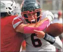  ?? Christian Abraham / Hearst Connecticu­t Media ?? Greenwich’s Logan Galletta, left, sacks Ridgefield QB Justin Keller during Saturday’s game at Boyle Stadium in Stamford.