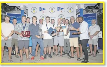  ?? ?? Kamal Powell (front row right) shares a moment with the winning team from Callisto Racing at the Appleton Estate sponsored Pineapple Cup - Montego Bay Race Awards Ceremony for 2023. The event was held at the Montego Bay Yacht Club in Freeport, St. James on January 25.