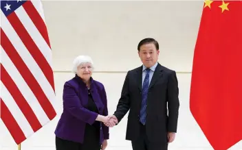  ?? — Reuters ?? US Treasury Secretary Janet Yellen and People’s Bank of China Governor Pan Gongsheng shake hands in Beijing.