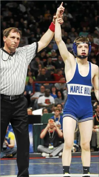  ?? PHOTOS BY STAN HUDY - SHUDY@DIGITALFIR­STMEDIA.COM ?? Maple Hill sophomore Trent Svingala has his hand raised as the NYSPHSAA Division I 106-pound champion at the Times Union Center Saturday night.