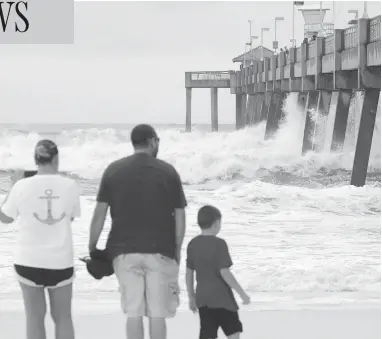  ?? NICK TOMECEK / NORTHWEST FLORIDA DAILY NEWS VIA AP ?? Waves crash against a fishing pier on Okaloosa Island in Fort Walton Beach, Fla., on Tuesday as Hurricane Michael approaches the northweste­rn part of the state. The hurricane is expected to make landfall on Wednesday afternoon.