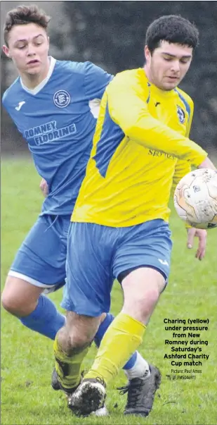  ?? Picture: Paul Amos FM5046971 ?? Charing (yellow) under pressure from New Romney during Saturday’s Ashford Charity Cup match