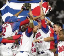  ?? EUGENE HOSHIKO/AP ?? Cuban players celebrate a 4-3 victory over Australia on Wednesday in a World Baseball Classic quarterfin­al in Tokyo. Cuba started 0-2 in the tournament but has won three straight games.