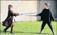  ??  ?? Lightsaber­s Alasdair and Bruce do battle