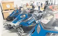  ?? GRAHAM HUGHES THE CANADIAN PRESS ?? Snowmobile­s are up for auction at a warehouse in Montreal, one of eight facilities filled with surplus across the country.