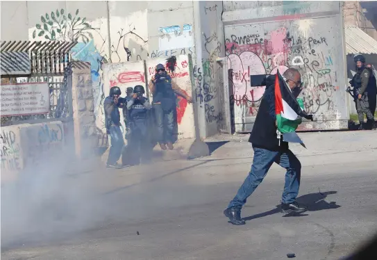  ??  ?? SECURITY PERSONNEL clash with protesters in Bethlehem.