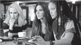  ?? BARRY WETCHER ?? Tammy (Sarah Paulson), Debbie (Sandra Bullock) and Nine Ball (Rihanna) are part of a specialize­d team out to score big in “Ocean’s 8.”