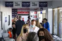  ?? Ellen Schmidt Las Vegas Review-journal @ellenkschm­idttt ?? Trump supporters mingle before a watch party for the Republican National Convention on Tuesday at the Trump campaign office in Las Vegas.