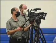  ?? BEN HASTY — MEDIANEWS GROUP ?? Cinematogr­aphers with Perlow Production­s, Brian DiRenzo, left, and John Zimmerman, right, film the graduation at Oley Valley High School where the district was holding graduation ceremonies for the 2020 seniors one at a time Wednesday afternoon May 27, 2020. Each graduating senior came to the school with their family members, and got to walk across the stage to receive their diploma as their name was called. Video was shot of them graduating, and will be edited together into a final video of everyone graduating. Normal graduation couldn’t be held due to the coronaviru­s / COVID-19 outbreak.