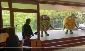  ?? Photograph: Henry Cooke/Henry Cooke/Stuff ?? New Zealand prime minister Jacinda Ardern was welcomed by a pair of dancing kiwi mascots in Japan.