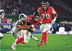  ?? USA Today Sports ?? Atlanta Falcons quarterbac­k Matt Ryan (2) is brought down by Los Angeles Rams outside linebacker Robert Quinn (94) during the first half on Saturday. Falcons won 26-13.