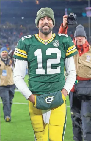  ?? MIKE DE SISTI/USA TODAY NETWORK-WISCONSIN ?? Packers quarterbac­k Aaron Rodgers is all smiles after helping defeat the Miami Dolphins on Sunday.