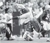  ?? JULIO CORTEZ AP ?? Navy linebacker Nicholas Straw, top, collides with Cincinnati tight end Josh Whyle, bottom, while going for a tackle of Whyle during the first half.