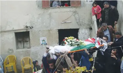  ?? (Abed Omar Qusini/Reuters) ?? MOURNERS CARRY the body of Samah Abdallah during her funeral in Amorya, near Nablus, on December 17, 2015.