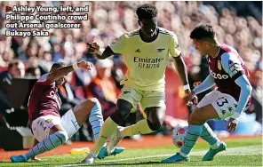  ?? ?? > Ashley Young, left, and Philippe Coutinho crowd out Arsenal goalscorer Bukayo Saka