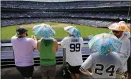  ?? FRANK FRANKLIN II - THE ASSOCIATED PRESS ?? Fans use umbrella hats to protect themselves from the sun during the sixth inning of a game between the New York Yankees and the Colorado Rockies Saturday, July 20, 2019, in New York.