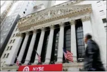  ?? THE ASSOCIATED PRESS ?? A pedestrian passes the New York Stock Exchange.