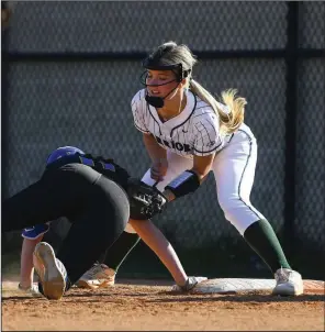  ?? (Arkansas Democrat-Gazette/Stephen Swofford) ?? Little Rock Christian first baseman Taylor Callahan (right) applies the tag as North Little Rock base runner Kelsey Barber slides back into first base during Thursday’s high school softball game at Little Rock.