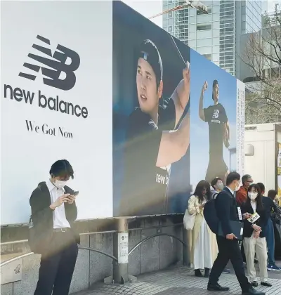  ?? HARUKA NUGA/AP ?? A billboard showing pictures of Shohei Ohtani hangs near a train staion in the famed Shibuya shopping district in Tokyo.