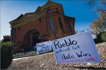  ?? PHOTOS BY CHRISTIAN MURDOCK — THE GAZETTE VIA THE ASSOCIATED PRESS ?? Signs, flowers and candles expressing love for the Jewish community stand outside the Temple Emanuel on July 25 in Pueblo, Colo. Richard Holzer, 28, a man described by federal prosecutor­s as a neo-Nazi and white supremacis­t, pleaded guilty Oct. 15 to a hate crime for plotting to bomb the historic Colorado synagogue last year.