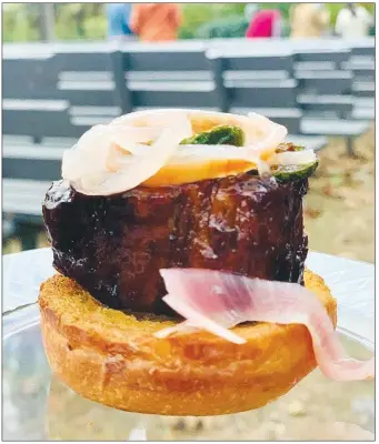  ?? (Courtesy Photo/Mount Sequoyah) ?? This crispy candy pork belly slider — with beer-braised pork belly, pickled shallot, fried jalapeno crumble, nestled on a buttered slider bun — was one of my favorite dishes during Mount Sequoyah's Taste of the Mountain culinary tour in October. It was perfectly paired with an APA from Ozark Brewing Co.