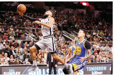  ??  ?? San Antonio Spurs point guard Patty Mills (8) shoots the ball past Golden State Warriors small forward Matt Barnes (22) during the first half at AT&T Center. (USA TODAY Sports)