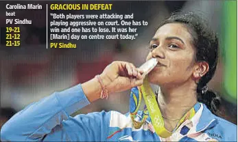  ?? REUTERS PHOTO ?? PV Sindhu, who said she is happy to win a silver, savours her historic podium finish after the women’s singles badminton final at the Rio Olympics on Friday.