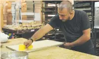  ?? Madi/Reuters) ?? TAHA RIZ prepares traditiona­l sweets inside a kitchen of his bakery in Tripoli last week.(Emilie