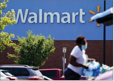  ?? (AP) ?? A shopper loads her car in the parking lot of a Walmart in Willow Grove, Pa., in this file photo. Walmart said Tuesday it will commercial­ize its delivery service to deliver other retailers’ products directly to customer homes.