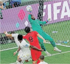  ?? | AFP ?? GHANA goalkeeper Lawrence Ati Zigi denies South Korea during their pulsating Group H clash at the Education City Stadium yesterday.