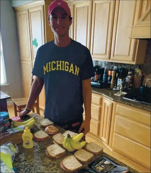  ?? COURTESY PHOTO ?? Jack Rasmussen assembles lunches for him and his best friend Quinton Markett to hand out to those in need in the Guadalupe River Park area of San Jose. Rasmussen and Markett called upon their previous volunteer experience to co-found Good Samaritans of Santa Clara Valley.