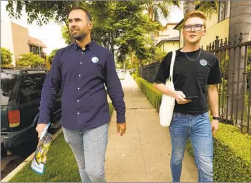  ?? Carolyn Cole Los Angeles Times ?? JIMMY BIBLARZ, left, and campaign manager Nick Wyville go door to door to talk to voters. “We haven’t said a bad word about any of our competitor­s,” says Biblarz, who is running for Councilman Paul Koretz’s seat.