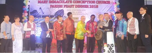  ??  ?? Ambrose (seventh left) and Fr Mathew Olilli (eighth left) jointly strike the gong to start the celebratio­n.